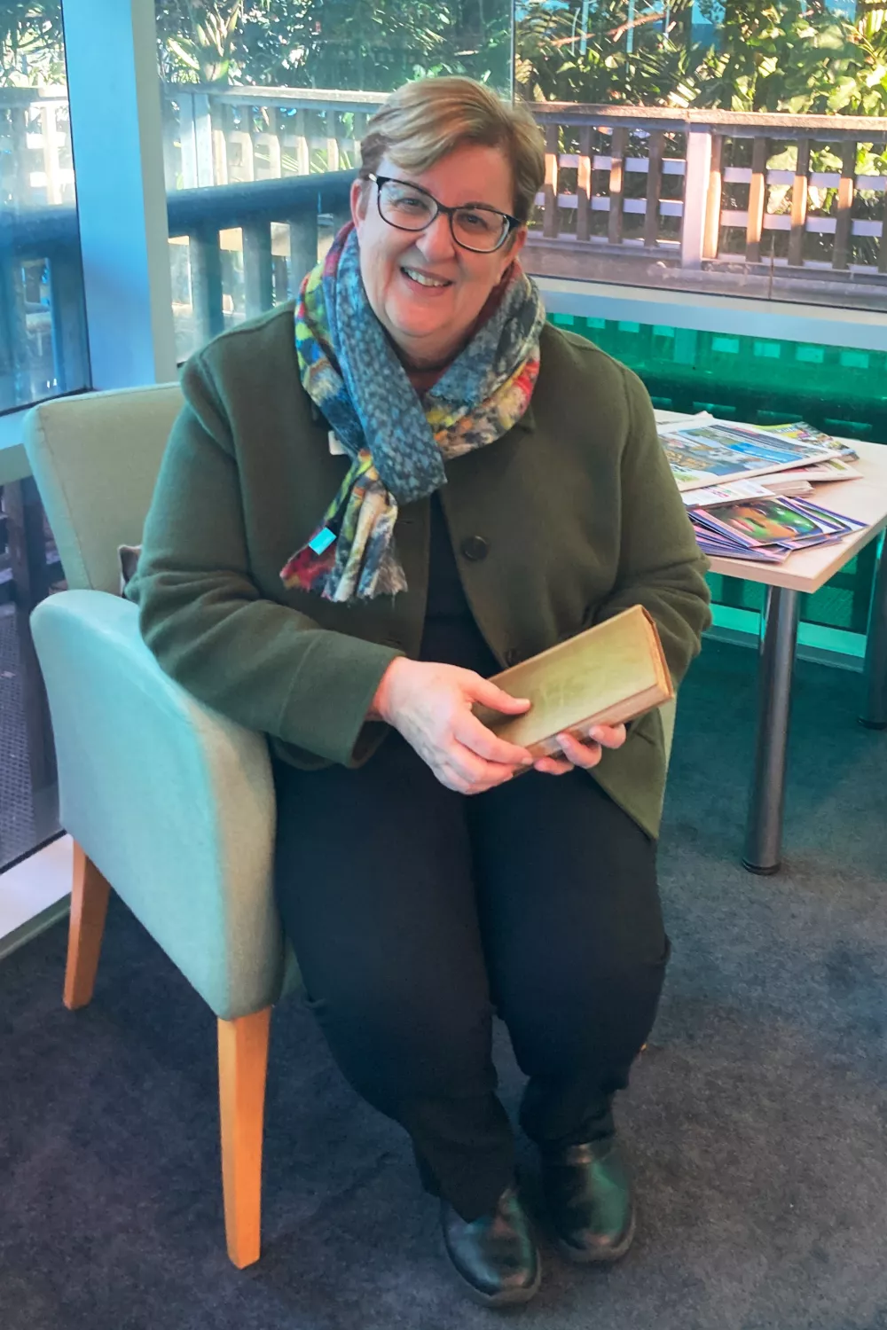 In this photo provided by Jane Thompson, library manager Michelle Hudson holds the book "Antiquities of Athens", after its return in Kiama, Australia, on Wednesday, July 29, 2026, an estimated 150 years late. (Jane Thompson via AP)