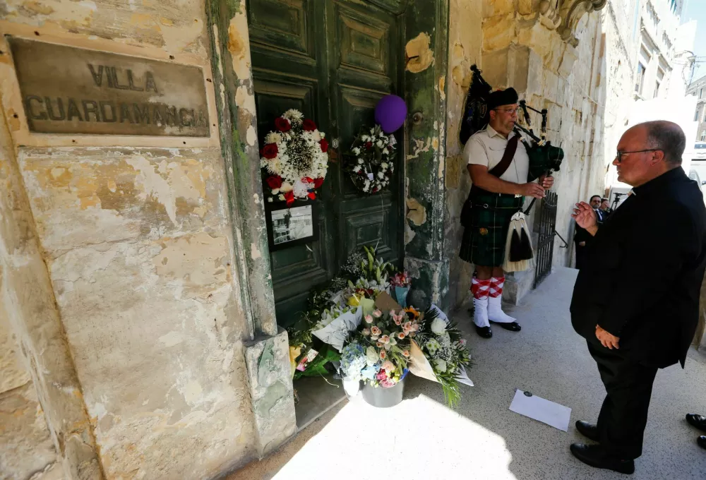 Malta's Archbishop Charles Scicluna lays flowers outside Villa Guardamangia, a former residence of Britain's then-Princess Elizabeth and Prince Philip between 1949 and 1951, to honour late Queen Elizabeth II in Pieta, Malta September 11, 2022. REUTERS/Darrin Zammit Lupi
