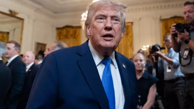 President Donald Trump speaks with a reporter as he departs after an event for Olympic athletes, coaches, staff, and representatives from Team USA in the East Room of the White House, Thursday, Aug. 6, 2026, in Washington. (AP Photo/Alex Brandon)