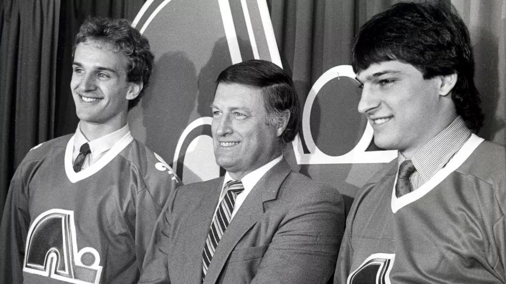 Maurice Filion, director manager of the Quebec Nordiques, welcomes Mario Brunetta, left, and Jason Lafreniere to the team, in Quebec City on June 4, 1986. Filion died Saturday morning at the age of 85.,Image: 343463854, License: Rights-managed, Restrictions: World rights excluding North America, Model Release: no / Foto: Jacques Nadeau Via Profimedia