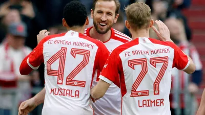 Soccer Football - Bundesliga - Bayern Munich v 1. FSV Mainz 05 - Allianz Arena, Munich, Germany - March 9, 2024 Bayern Munich's Harry Kane celebrates scoring their seventh goal to complete his hat-trick with Jamal Musiala and Konrad Laimer REUTERS/Michaela Stache DFL REGULATIONS PROHIBIT ANY USE OF PHOTOGRAPHS AS IMAGE SEQUENCES AND/OR QUASI-VIDEO. TPX IMAGES OF THE DAY