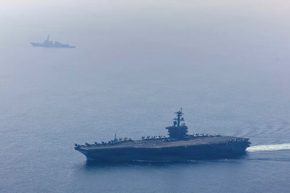 The U.S. Navy's Nimitz-class aircraft carrier USS Abraham Lincoln and Arleigh Burke-class guided-missile destroyer USS Frank E. Petersen Jr. sail during a photo exercise in the Arabian Sea, February 6, 2026. U.S. Navy/Mass Communication Specialist 1st Class Jesse Monford/Handout via REUTERS THIS IMAGE HAS BEEN SUPPLIED BY A THIRD PARTY