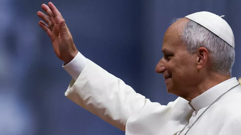 Pope Leo greets the faithful as he arrives to hold the weekly general audience in St. Peter's Basilica at the Vatican, August 12, 2026. REUTERS/Guglielmo Mangiapane