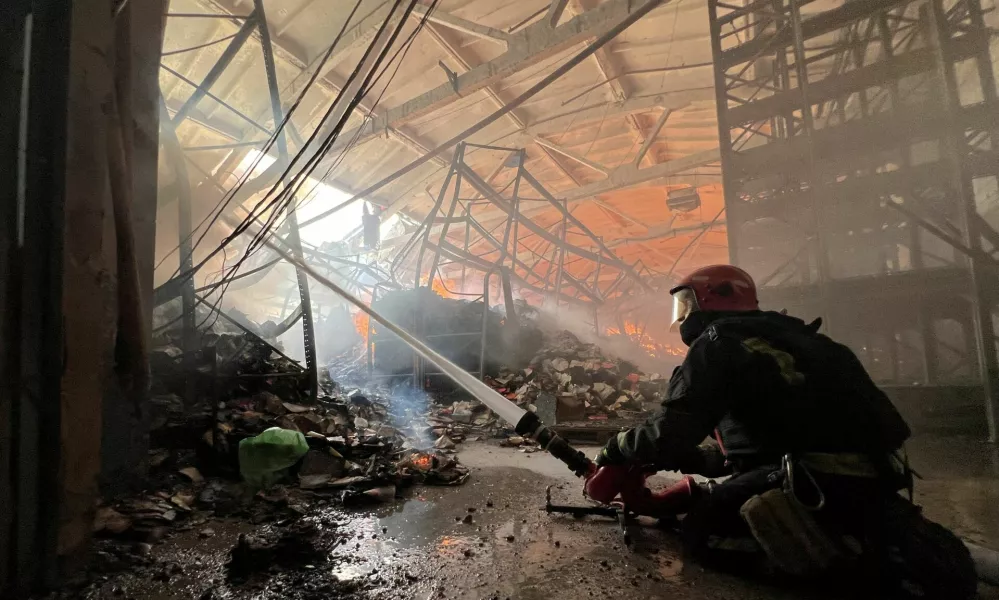 FILE PHOTO: A firefighter works at the site of a book warehouse hit by a Russian drone strike, amid Russia's attack on Ukraine, in Kharkiv, Ukraine, August 1, 2026. Picture taken with a mobile phone. REUTERS/Volodymyr Pavlov/File Photo