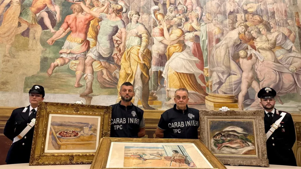 Carabinieri officers pose with three paintings by Paul Cezanne, Henri Matisse and Pierre-Auguste Renoir recovered after they were stolen from the Magnani Rocca Foundation in Mamiano, Italy, in this handout image released on August 14, 2026. Carabinieri/Handout via REUTERS THIS IMAGE HAS BEEN SUPPLIED BY A THIRD PARTY.
