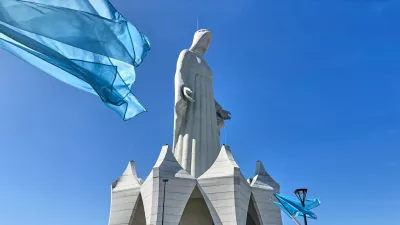 Flags wave in the wind in front of an enormous statue of the Virgin Mary that is believed to be Europe's tallest during the inauguration in the village Konotopie, Poland, Saturday, Aug. 15, 2026. (AP Photo/Claudia Ciobanu) / Foto: Claudia Ciobanu