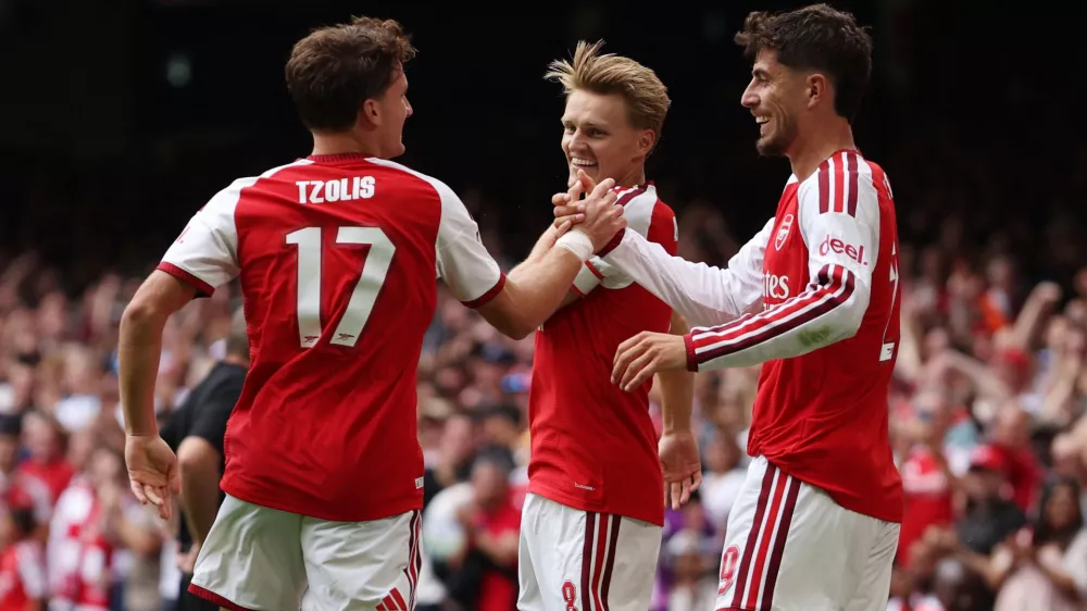 Soccer Football - FA Community Shield - Arsenal v Manchester City - Principality Stadium, Cardiff, Wales, Britain - August 16, 2026 Arsenal's Martin Odegaard celebrates scoring their third goal with Christos Tzolis and Kai Havertz REUTERS/Chris Radburn