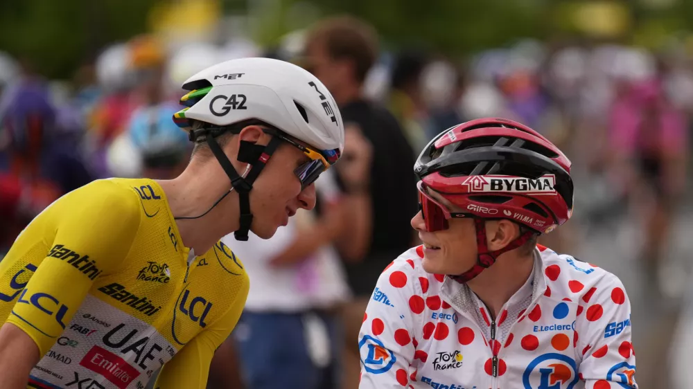 Slovenia's Tadej Pogacar, wearing the overall leader's yellow jersey, talks to Denmark's Jonas Vingegaard, wearing the best climber's dotted jersey, before the start of the eleventh stage of the Tour de France cycling race with start in Vichy and finish in Nevers, France, Wednesday, July 15, 2026. (AP Photo/Mosa'ab Elshamy)