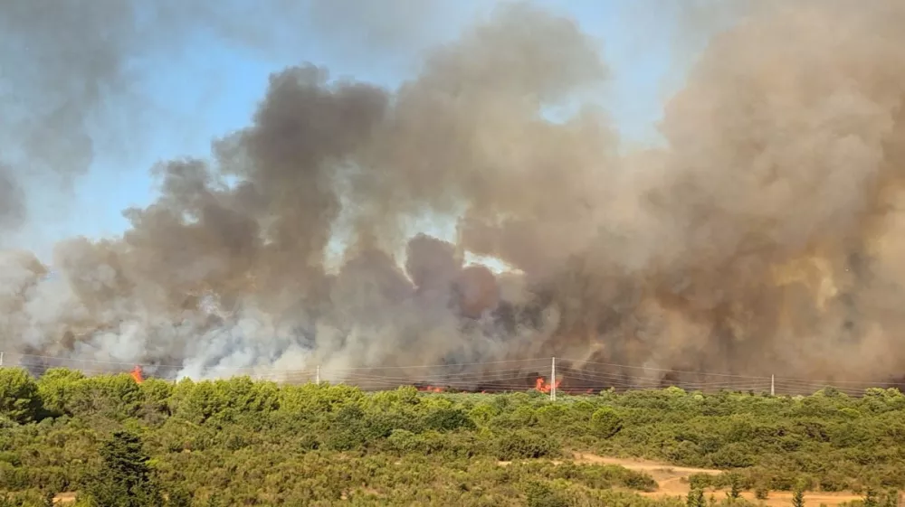 Smoke and flames rise from a wildfire in Zadar, Croatia, August 14, 2026, in this screen grab obtained from a social media video. DOMINIK BRKLJACA/via REUTERS THIS IMAGE HAS BEEN SUPPLIED BY A THIRD PARTY. MANDATORY CREDIT. NO RESALES. NO ARCHIVES. Verification: -Buildings, terrain and roads that matched the archive and satellite imagery of the area. -Coordinates: 44.162936, 15.227675. -Original file metadata. -Croatian Fire Service reports of the fire.