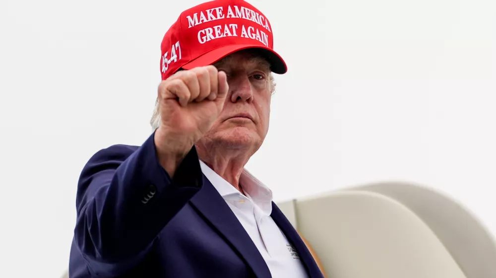 President Donald Trump gestures while boarding Air Force One at Morristown Airport, Sunday, Aug. 16, 2026, in Morristown, N.J. (AP Photo/Julia Demaree Nikhinson)