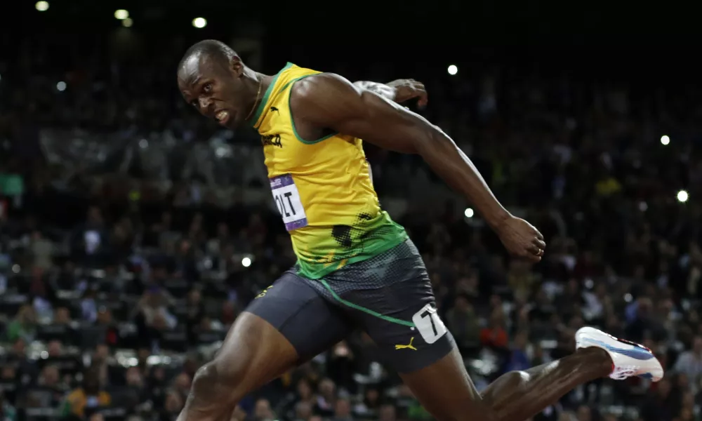 Jamaica's Usain Bolt crosses the finish line to win gold in the men's 100-meter final during the athletics in the Olympic Stadium at the 2012 Summer Olympics, London, Sunday, Aug. 5, 2012. (AP Photo/David J. Phillip)