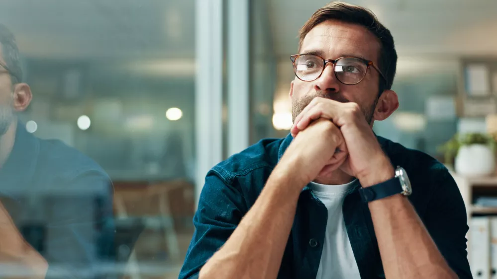 Reflection, thinking and business man with idea, creative insight or professional mindset. Planning, vision and serious worker with inspiration, problem solving and writer by glass in startup office