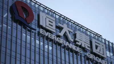 FILE - The Evergrande Group headquarters logo is seen in Shenzhen in southern China's Guangdong province on Sept. 24, 2021. A top executive of China Evergrande's electric vehicle company has been detained by police in the latest sign of trouble for the world's most heavily indebted property developer. (AP Photo/Ng Han Guan, File)