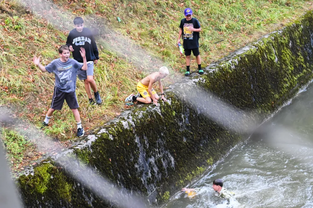 LA young fans jumping into Ljubljanica river after one signed jersey fell into the river. Los Angeles Lakers star Luka Doncic takes his teammates on a sightseeing boat tour of Ljubljana during the team's visit to the Slovenian capital. Doncic is hosting his Lakers teammates in his hometown as part of a four-day team gathering ahead of the new NBA season. The group toured the city by boat, taking in Ljubljana's historic city centre and landmarks along the Ljubljanica River.