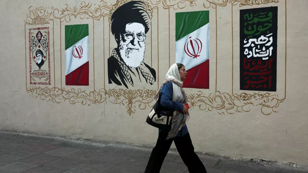 A woman walks by a mural depicting Iran's late Supreme Leader Ayatollah Ali Khamenei, on a street in Tehran, Iran, August 13, 2026. Majid Asgaripour/WANA (West Asia News Agency) via REUTERS ATTENTION EDITORS - THIS PICTURE WAS PROVIDED BY A THIRD PARTY. ISRAEL OUT. NO COMMERCIAL OR EDITORIAL SALES IN ISRAEL. NO ACCESS FOR ISRAELI MEDIA. NO USE BBC PERSIAN. NO USE VOA PERSIAN. NO USE MANOTO. NO USE IRAN INTERNATIONAL. NO USE RADIO FARDA. DIGITAL: NO USE BBC PERSIAN. NO USE VOA PERSIAN. NO USE MANOTO. NO USE IRAN INTERNATIONAL. NO USE RADIO FARDA.