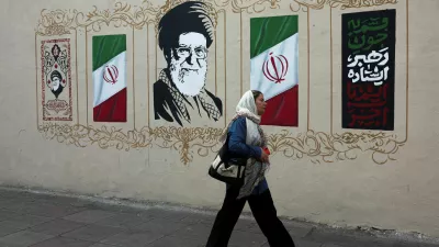 A woman walks by a mural depicting Iran's late Supreme Leader Ayatollah Ali Khamenei, on a street in Tehran, Iran, August 13, 2026. Majid Asgaripour/WANA (West Asia News Agency) via REUTERS ATTENTION EDITORS - THIS PICTURE WAS PROVIDED BY A THIRD PARTY. ISRAEL OUT. NO COMMERCIAL OR EDITORIAL SALES IN ISRAEL. NO ACCESS FOR ISRAELI MEDIA. NO USE BBC PERSIAN. NO USE VOA PERSIAN. NO USE MANOTO. NO USE IRAN INTERNATIONAL. NO USE RADIO FARDA. DIGITAL: NO USE BBC PERSIAN. NO USE VOA PERSIAN. NO USE MANOTO. NO USE IRAN INTERNATIONAL. NO USE RADIO FARDA.