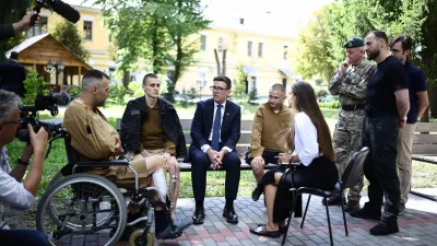 Britain's prime minister Andy Burnham gestures as he meets patients wounded in the war at the Main Military Hospital, supported by the David Nott Foundation, a UK charity who have trained over 1,000 Ukrainian surgeons, anaesthetists and other healthcare workers, in Kyiv on August 24, 2026. (Henry Nicholls/Pool photo via AP)