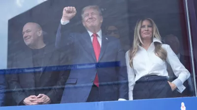 President Donald Trump, first lady Melania Trump and Dana White watch after Kyle Kirkwood (27) won the IndyCar Freedom 250 Grand Prix auto race in Washington, Sunday, Aug. 23, 2026. (AP Photo/Alex Brandon)