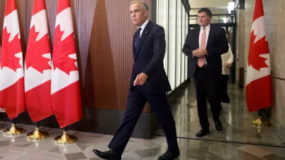 Prime Minister Mark Carney and Canada-U.S. Trade Minister Dominic LeBlanc arrive at a news conference about Canada's response to new U.S. tariffs on Parliament Hill in Ottawa on Saturday, Aug. 22, 2026. (Patrick Doyle/The Canadian Press via AP)