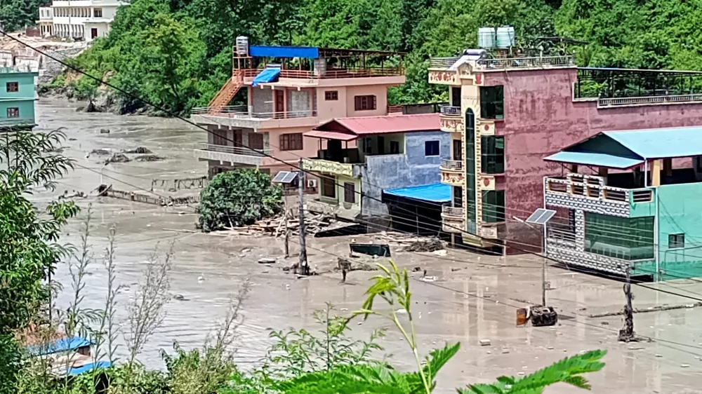 A flooded road following a flash flood in Galchhi in the Dhading district, Nepal, August 26, 2026. Picture taken with a mobile phone. REUTERS/Stringer   TPX IMAGES OF THE DAY