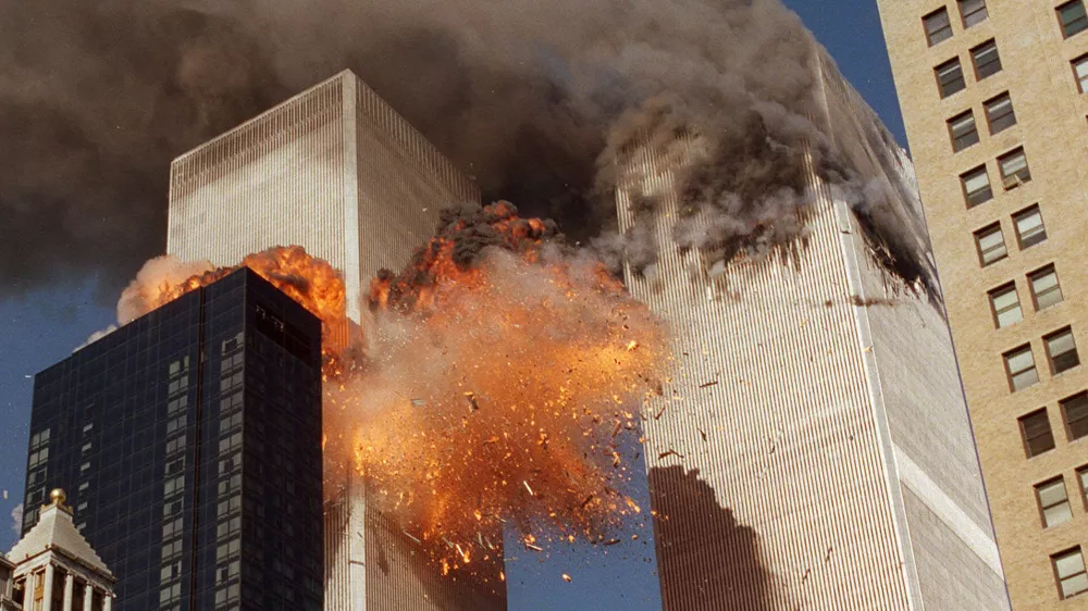 THIRD OF A SERIES OF FOUR PHOTOS--Smoke billows from one of the towers of the World Trade Center and flames and debris explode from the second tower, Tuesday, Sept. 11, 2001. In one of the most horrifying attacks ever against the United States, terrorists crashed two airliners into the World Trade Center in a deadly series of blows that brought down the twin 110-story towers. (AP Photo/Chao Soi Cheong)
