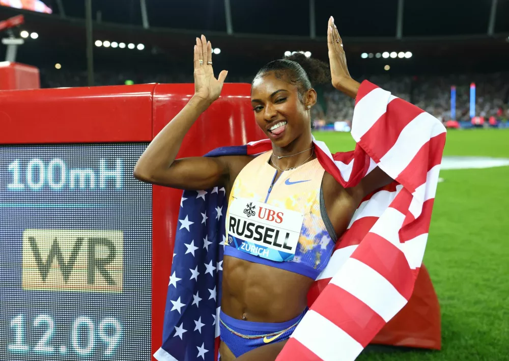 Athletics - Diamond League - Zurich - Letzigrund, Zurich, Switzerland - August 27, 2026 Masai Russell of the U.S. poses with a screen after winning the women's 100m hurdles final and setting a new world record REUTERS/Denis Balibouse