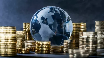 Globe and stack with coins. Money makes the world go round / Foto: Gopixa