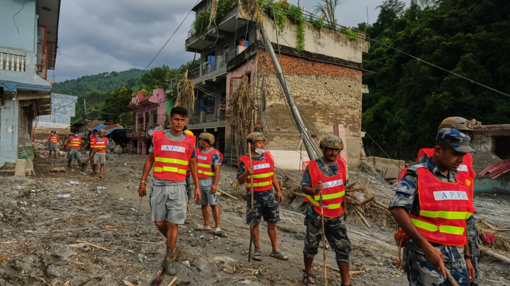 Workers clear debris in the aftermath of a flash flood in the Devighat area of Nuwakot district in Nepal, Friday, Aug. 28, 2026. (AP Photo/Rajesh Kumar Singh)