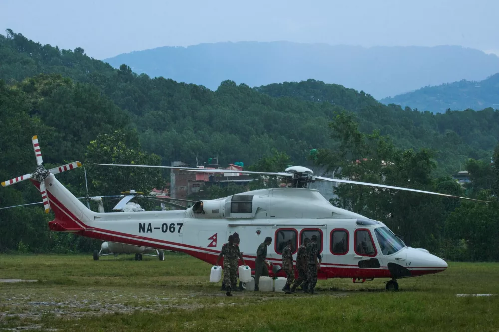 Nepalese Army soldiers refuel a helicopter before it takes off for a rescue operation in the aftermath of flash flooding in the Nuwakot district of Nepal, Friday, Aug. 28, 2026. (AP Photo/Niranjan Shrestha)