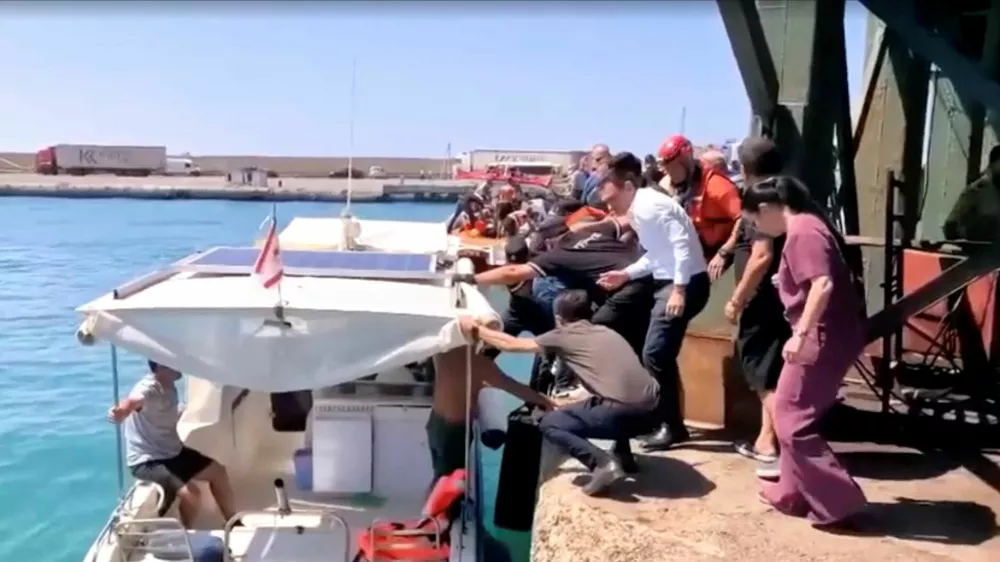 Rescue boats bring passengers to shore from capsized boat in northern Cyprus, August 30, 2026 in this screengrab taken from a video. REUTERS/Reuters TV