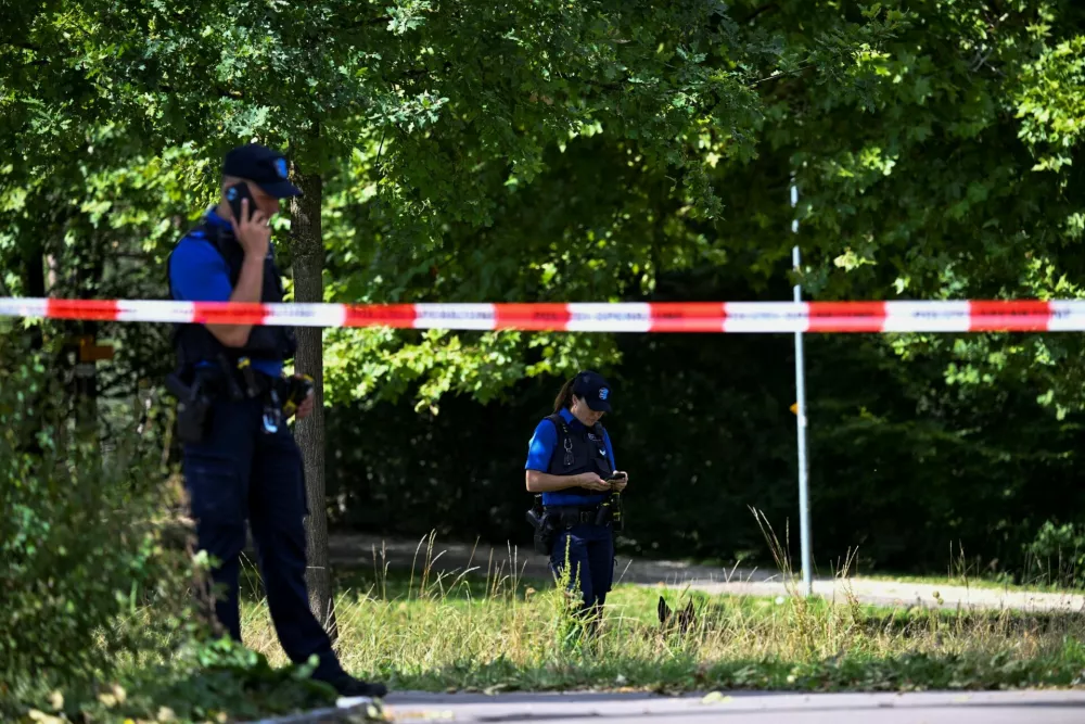 Police stand next to barricade tape near the site of a deadly shooting at a rave party, according to the police, at Schachen in Aarau, Switzerland, August 30, 2026. REUTERS/Romina Amato   TPX IMAGES OF THE DAY