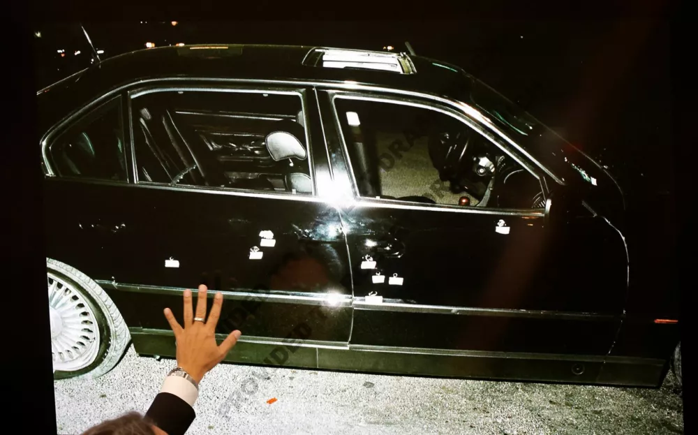 A 1996 photo of the bullet-ridden black BMW, that Marion "Suge" Knight and Tupac Shakur were riding in, is displayed as Michael Sanft, defense attorney for Duane Davis, makes closing arguments in the Duane Davis murder trial, related to the 1996 killing of rapper Tupac Shakur, in Clark County District Court at the Regional Justice Center in Las Vegas, Nevada, U.S., August 31, 2026. REUTERS/Steve Marcus/Pool   