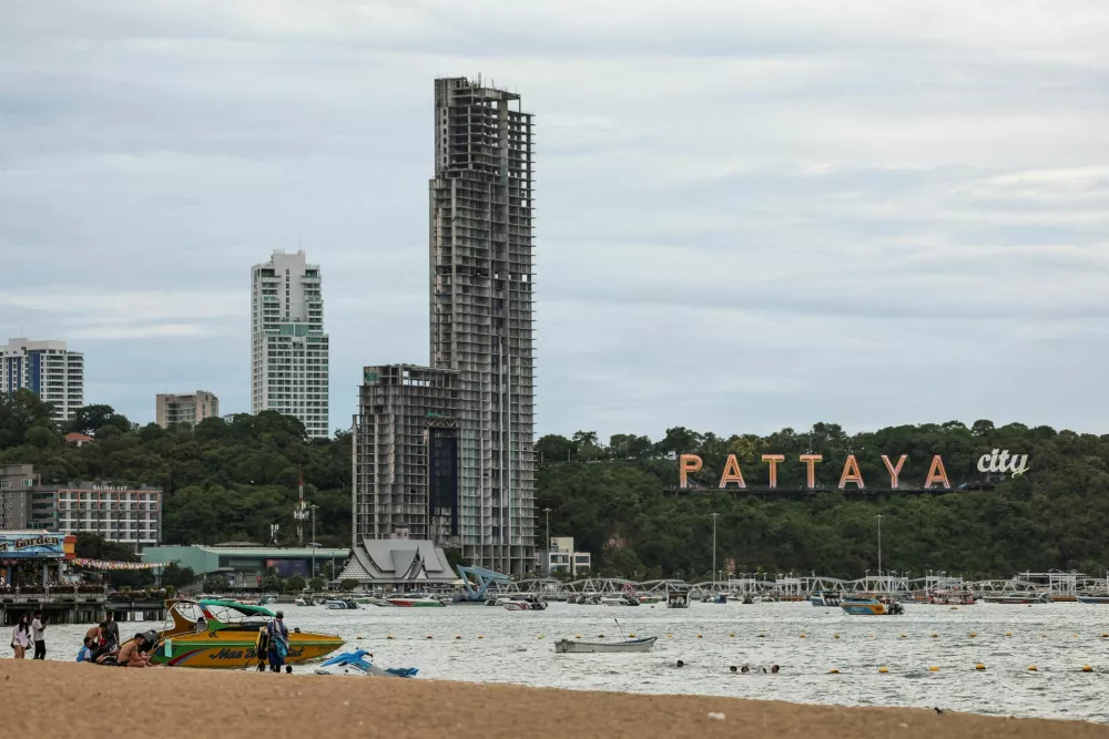 People relax at Pattaya Beach with the Pattaya City sign in the background in Pattaya City, Thailand, June 29, 2026. REUTERS/Chalinee Thirasupa
