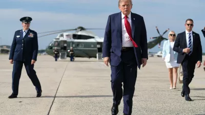 FILE - President Donald Trump, center, walks from Marine One to board Air Force One, Aug. 21, 2026, at Joint Base Andrews, Md., en route to South Carolina. (AP Photo/Jacquelyn Martin, File)