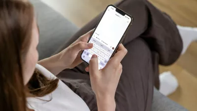 Poznan, Poland – April 14, 2025: A woman holding a smartphone and typing a question to the ChatGPT AI assistant, using a conversational text interface on the app,Image: 991604543, License: Royalty-free, Restrictions:, Model Release: no 