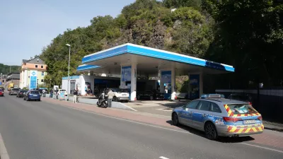 21 September 2021, Rhineland-Palatinate, Idar-Oberstein: A police car is seen parked near a petrol station where a cashier was shot dead apparently over a dispute about wearing a face mask. Photo: Thomas Frey/dpa