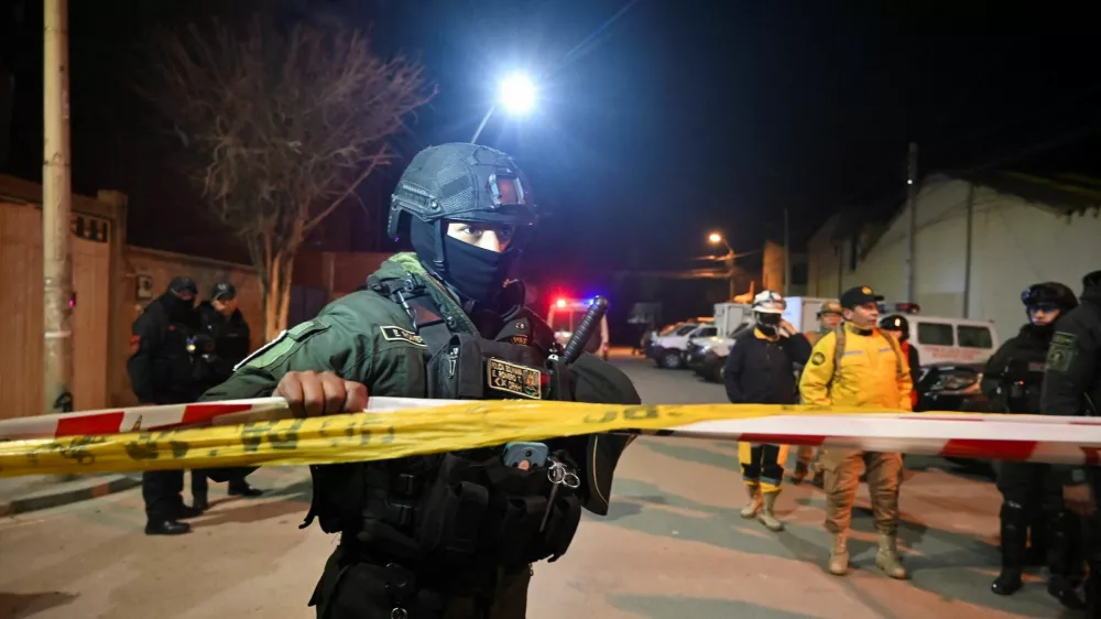 A police officer holds a caution tape after explosions that left people dead and injured at the "Bolivar" Mechanized Artillery Regiment, in Viacha, Bolivia, September 4, 2026. REUTERS/Claudia Morales