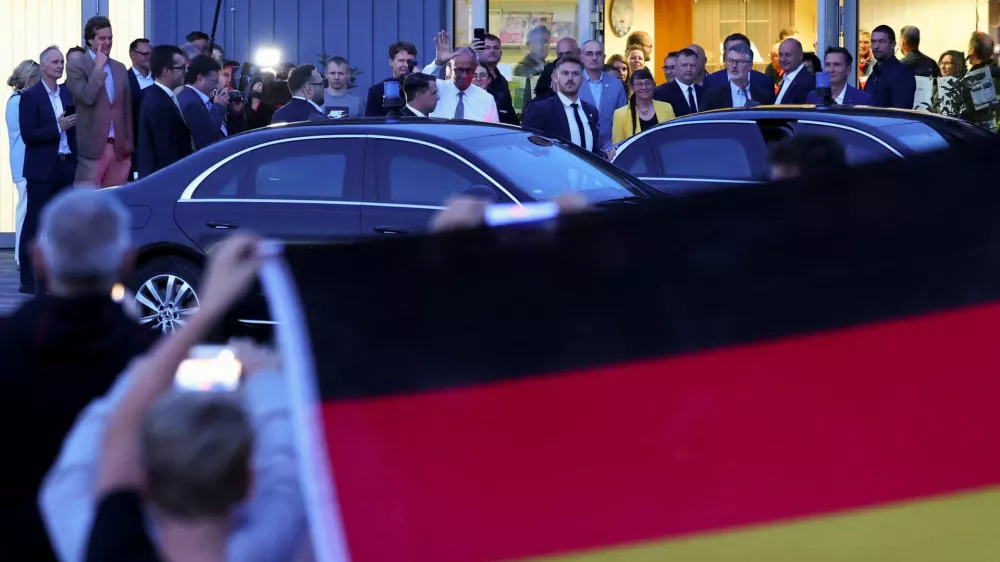 People protest as German Chancellor and Christian Democratic Union (CDU) party leader Friedrich Merz leaves a closed meeting with supporters in Braunsbedra, Germany, September 3, 2026. REUTERS/Christian Mang