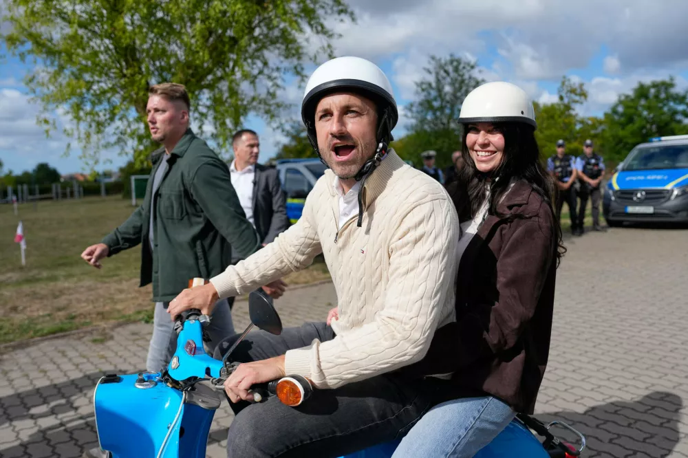 Ulrich Siegmund, top candidate for the "Alternative for Germany" (AfD) party leaves with his wife Julia on a small Schwalbe motorcycle after their voting at a polling station during the Saxony-Anhalt state elections in Tangermuende, eastern Germany, Sunday, Sept. 6, 2026. (AP Photo/Matthias Schrader)