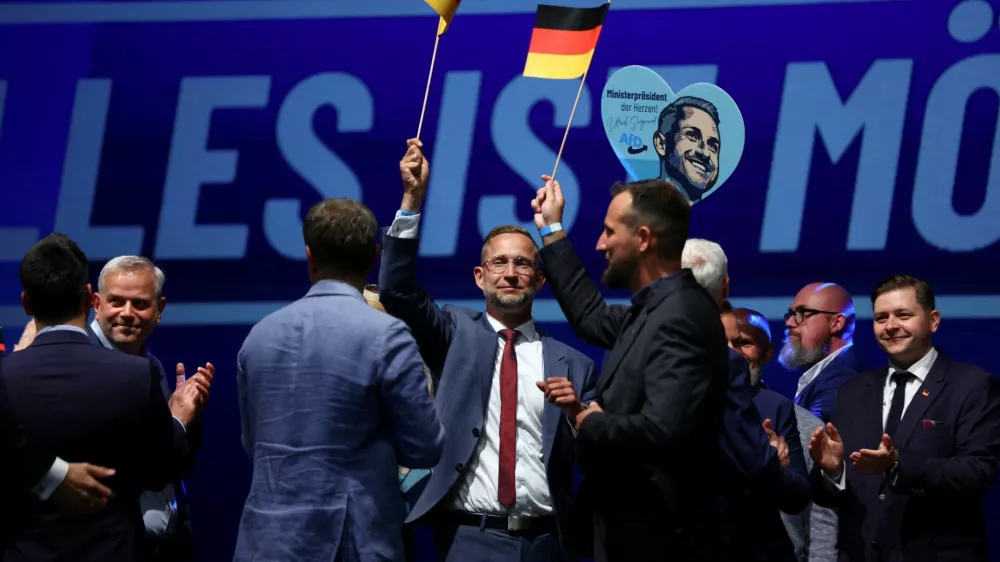 Supporters of far-right Alternative for Germany (AfD) hold German flags after polls closed in the Saxony-Anhalt state elections, in Magdeburg, Germany, September 6, 2026. REUTERS/Thilo Schmuelgen