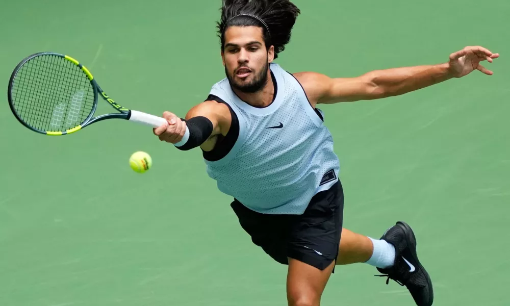Carlos Alcaraz, of Spain, returns the ball to Tommy Paul, of the United States, during the fourth round of the U.S. Open tennis championships Sunday, Sept. 6, 2026, in New York. (AP Photo/Yuki Iwamura)