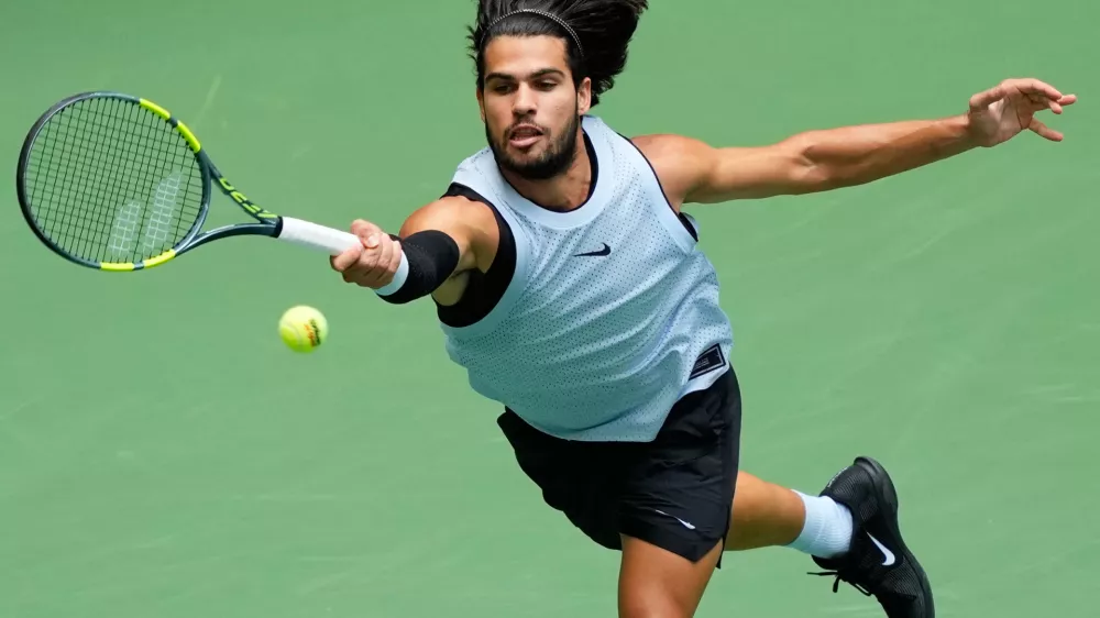Carlos Alcaraz, of Spain, returns the ball to Tommy Paul, of the United States, during the fourth round of the U.S. Open tennis championships Sunday, Sept. 6, 2026, in New York. (AP Photo/Yuki Iwamura)