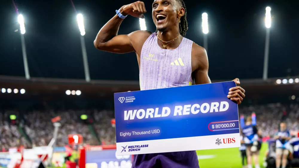 Brazil's Alison dos Santos celebrates winning the men's 400-meter hurdles, setting a new world record, at the Diamond League athletics meeting, Thursday, Aug. 27, 2026, in Zurich, Switzerland. (Jean-Christophe Bott/Keystone via AP)