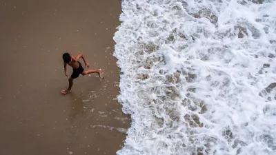 A child runs from the water as large waves from Hurricane Marie break on the shore, Monday, Sept. 7, 2026, on Huntington Beach, southern Calif. (AP Photo/Ethan Swope)