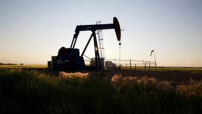 An oil pump jack pumps oil in a field near Calgary, Alberta, July 21, 2014. Pump jacks are used to pump crude oil out of the ground after an oil well has been drilled. REUTERS/Todd Korol