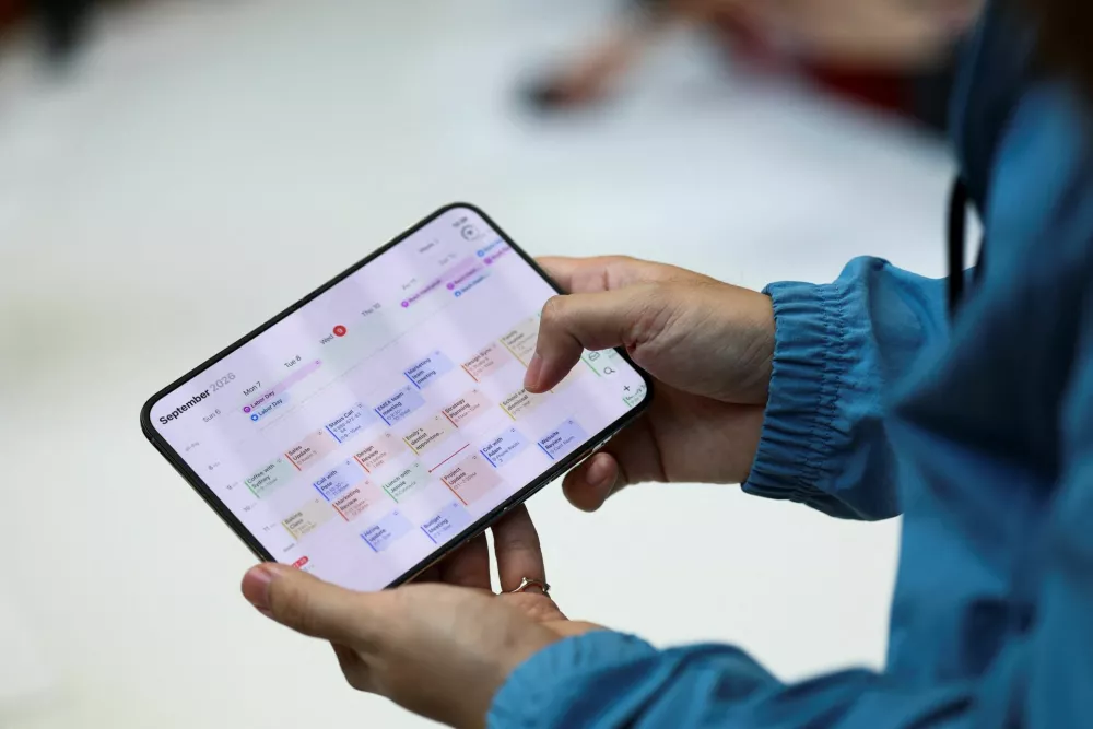 A person holds the new foldable iPhone Duo during Apple's event at the Steve Jobs Theater in Cupertino, California, U.S. September 9, 2026. REUTERS/Carlos Barria