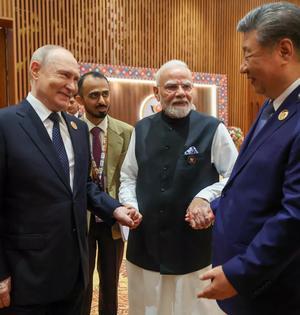 India's Prime Minister Narendra Modi, Russian President Vladimir Putin and Chinese President Xi Jinping hold hands at Bharat Mandapam, the venue of BRICS Summit in New Delhi, India, September 12, 2026. India's Ministry of External Affairs/Handout via REUTERS THIS IMAGE HAS BEEN SUPPLIED BY A THIRD PARTY. NO RESALES. NO ARCHIVES. TPX IMAGES OF THE DAY.