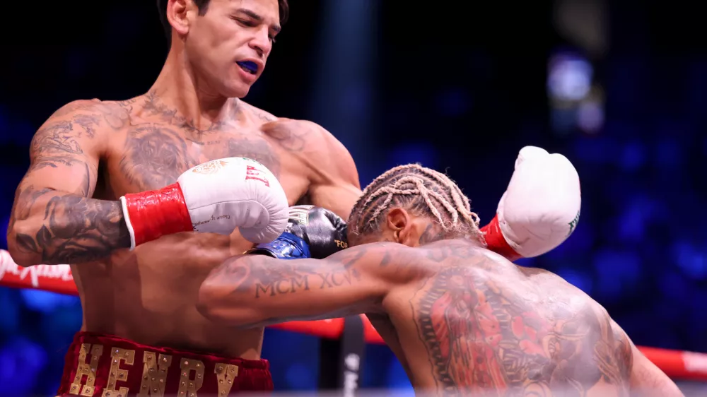 Ryan Garcia, left, punches Conor Benn in their welterweight championship fight Saturday, Sept. 12, 2026, in Las Vegas. (AP Photo/Ian Maule)