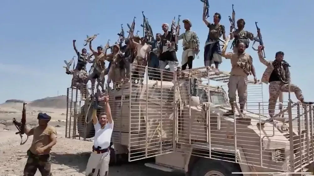 This image taken from undated video released by the Houthi-run Al-Masirah television channel on Saturday, Sept. 12, 2026, shows Houthi fighters chanting and raising rifles atop a military vehicle in Dhubab district, Taiz province, Yemen, according to the channel. (Al-Masirah TV via AP)