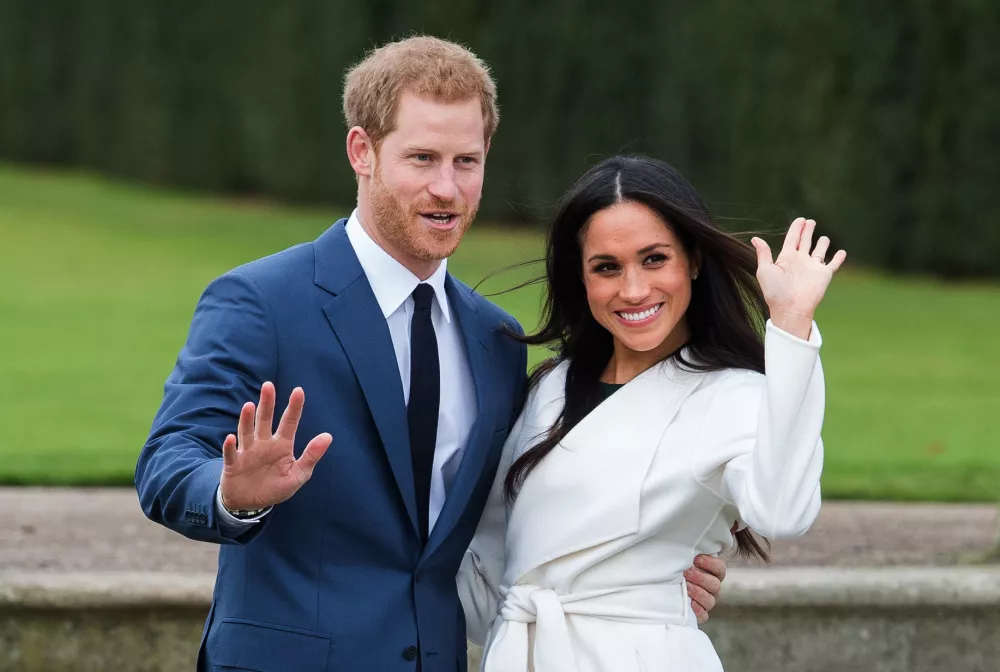 LONDON, ENGLAND - NOVEMBER 27: Prince Harry and Meghan Markle, wearing a white belted coat by Canadian brand Line The Label, attend a photocall in the Sunken Gardens at Kensington Palace following the announcement of their engagement on November 27, 2017 in London, England. (Photo by Anwar Hussein/Getty Images)